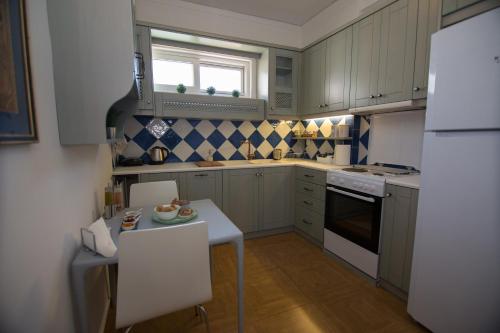 a small kitchen with a table and a refrigerator at Centro Urban Chania in Chania