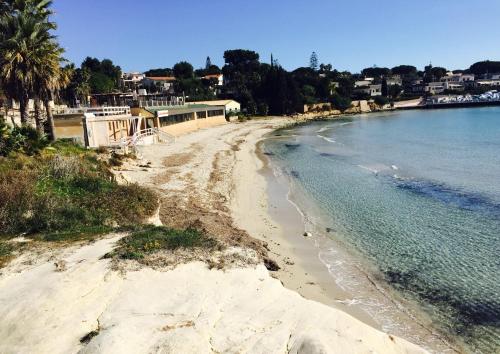 a view of a beach next to the water at White Bay in Fontane Bianche