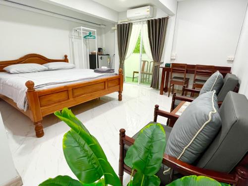 a bedroom with a bed and chairs and a table at Number9 Bangkoknoi BKK Homestay in Bangkok