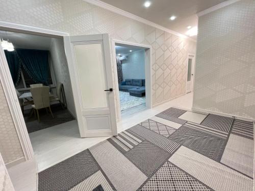 Cette chambre dispose d'un couloir avec une porte et d'un salon. dans l'établissement Жана кала 3 комнатная квартира, à Tridtsatʼ Let Kazakhstana