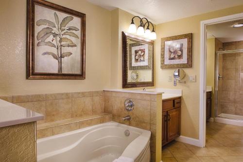 a bathroom with a bath tub and a sink at Club Wyndham Bonnet Creek in Orlando