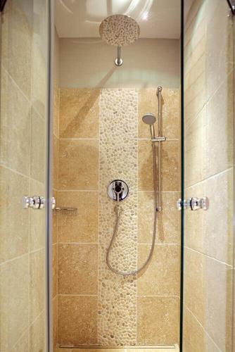 a shower with a glass door in a bathroom at Schafstall, mit Sauna, in Hörnum, Sylt - 1 Hund willkommen in Hörnum