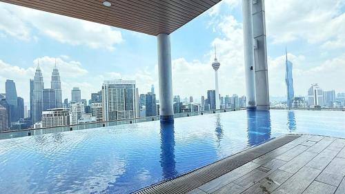 a swimming pool on top of a building with a city skyline at The Colony Infinity By Castel in Kuala Lumpur