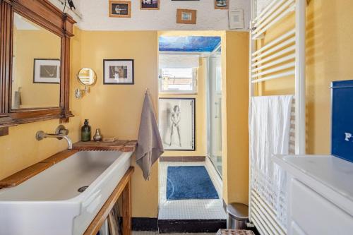 a bathroom with a tub and a sink and a mirror at The Terrace of San Pellegrino - Historic Center in Viterbo