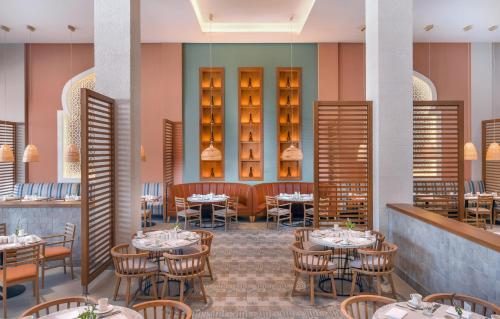 a rendering of a restaurant with tables and chairs at Steigenberger Resort Ras Soma in Hurghada