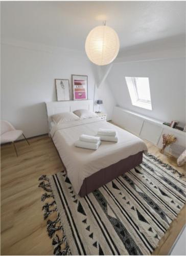 a bedroom with a large bed and a rug at Stubel-Riedisheim in Riedisheim
