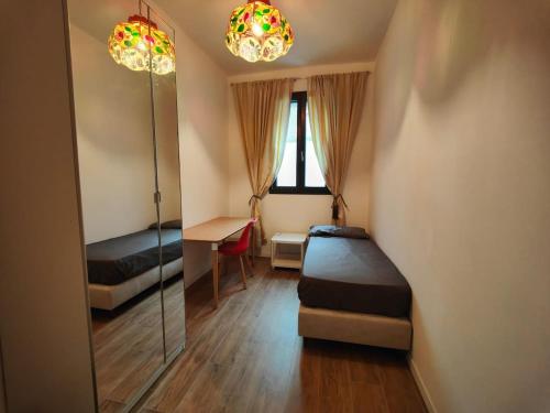 Un dormitorio con dos camas y un espejo. en Casa Sanseveria, en Módena