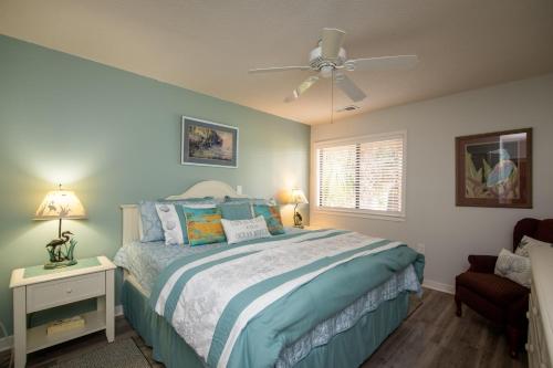 una camera da letto con un letto e un ventilatore a soffitto di Club Cottage 824 - CLARITY a Edisto Beach