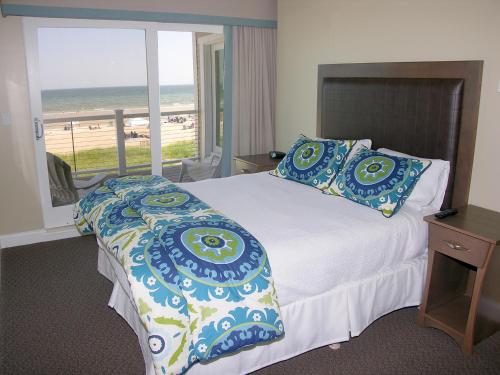 a bedroom with a bed with a view of the beach at Alouette Sunrise Suites in Old Orchard Beach