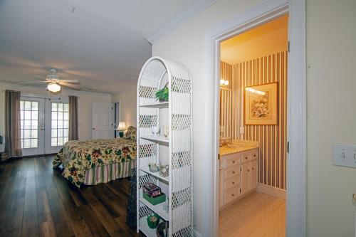 a room with a room with a bed and a shelf at Marsa's Place in Edisto Island