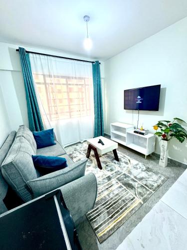 TV a/nebo společenská místnost v ubytování Queens Stay Apartment