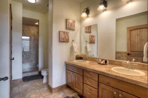 a bathroom with two sinks and a shower at Peregrine Point 106 in Durango Mountain Resort