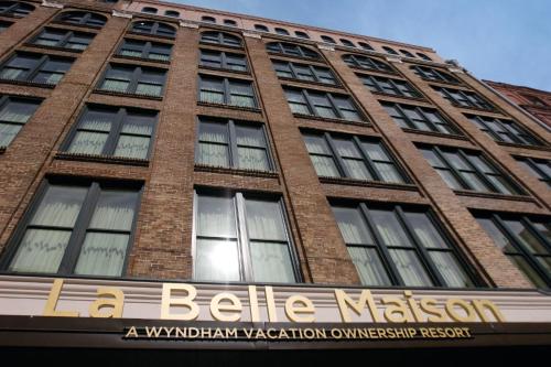 a tall brick building with a sign on it at Club Wyndham La Belle Maison in New Orleans