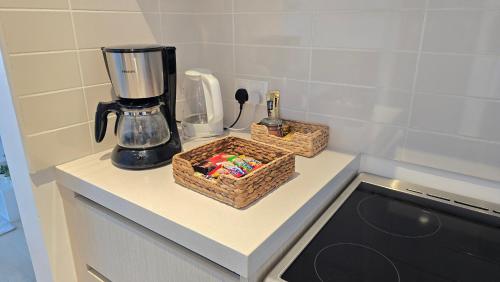 a kitchen counter with a blender and baskets on it at F1 - Lily Studio Waters Edge Yas Island Theme Parks, Canal and Pool View in Abu Dhabi