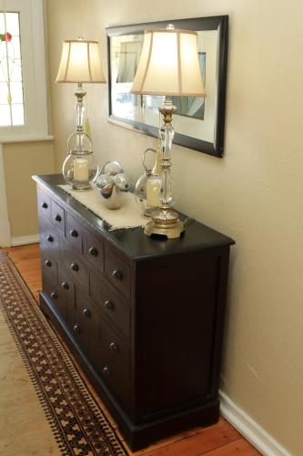 a black dresser with a lamp on top of it at Oxford Lodge Vryheid in Vryheid