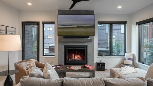 a living room with a couch and a fireplace at Principal House in Steamboat Springs