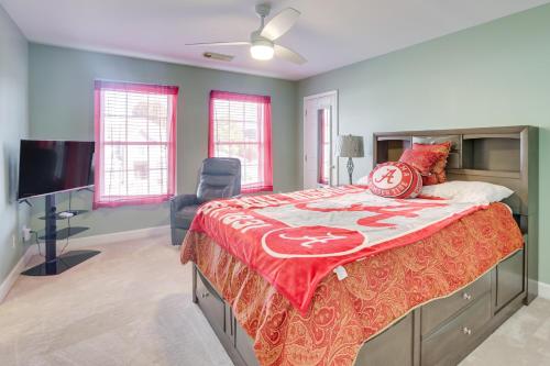 a bedroom with a large bed and a television at 8 Mi to University of Alabama Family Home with Yard in Englewood