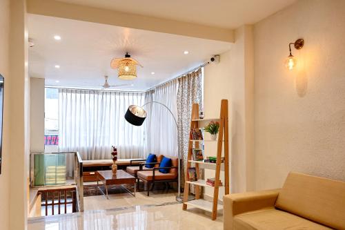 a living room with a couch and a table at The Nest in Varanasi