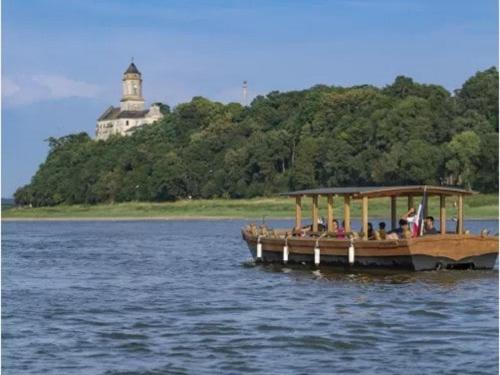 a group of people on a boat on the water at Appartement proche Ancenis - Loire et Vélo in Liré