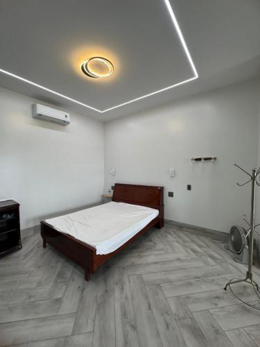 a bedroom with a bed in a room with wooden floors at Two-bedroom flat - River view, elevator, free inside car parking in Mỹ Phước