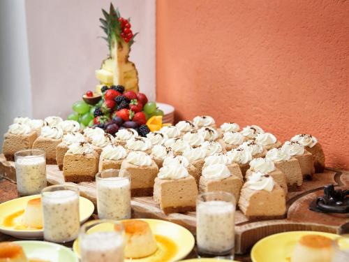 a table topped with cakes and other food on plates at Familienhotel Hinteregger in Katschberghöhe