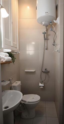 a white bathroom with a toilet and a sink at City Stars Hotel in Cairo