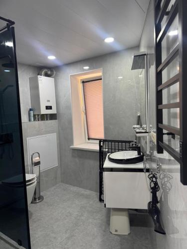a bathroom with a sink and a toilet at Samarkand Central Apartments in Samarkand