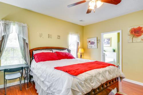 a bedroom with a large bed with red pillows at Georgia Vacation Rental 14 Mi to Downtown Augusta in Hephzibah