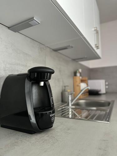 a black coffee pot sitting on a kitchen counter at Apartment in Rittersdorf in Rittersdorf