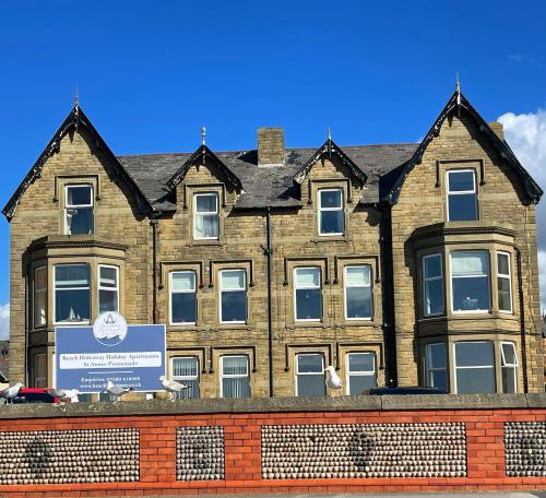 a large brick building with a sign in front of it at Pier View in Lytham St Annes