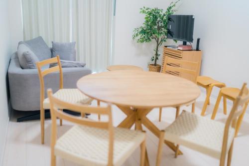 a living room with a table and chairs and a couch at Greenfield - Vacation STAY 20425 in Sasebo