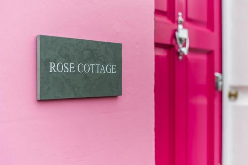 a pink door with a sign that reads rose cottage at Rose cottage, Central, Amazing Cathedral view, Iconic pastel street in Canterbury