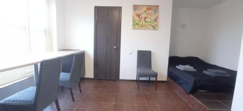 a room with a bed and a table and chairs at БіднийЗаяць in Lebedevka