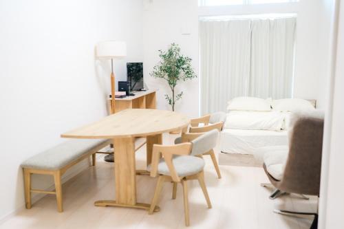 a living room with a wooden table and chairs at Greenfield - Vacation STAY 20422 in Sasebo