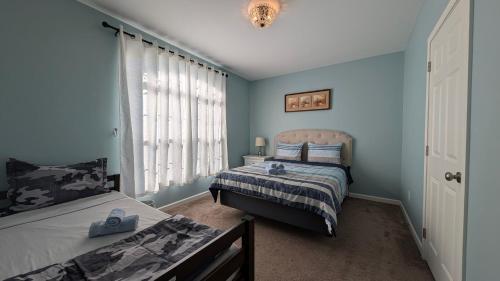 a bedroom with two beds and a window at Spacious Entire home close to HoliMont and Village in Ellicottville