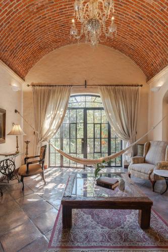 a living room with a couch and a table at Villa Ganz Boutique Hotel in Guadalajara
