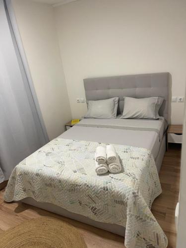 a bed with two pairs of shoes on it at Casa Ferreira em Fátima in Fátima