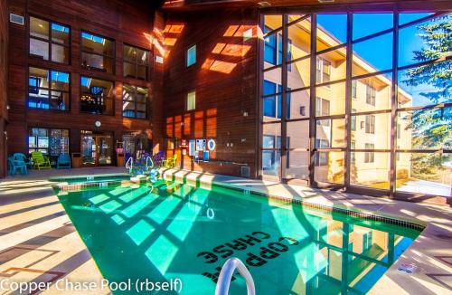 a swimming pool in front of a building at Royal Vista III Pool-Spa Ski-in out Gym, Sauna, Laundry, BBQ in Brian Head