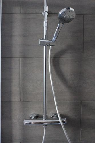 a shower with a blow dryer in a bathroom at Casa Kokoro in Staranzano