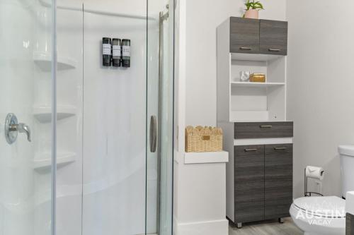 a bathroom with a shower with a glass door at Pet Friendly 3BR 3BA Hill Country Home w Private Pool and Grill by Austin Vacay in Buffalo Gap