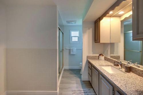 a bathroom with a sink and a mirror at Relaxing Pool Side - Near Fairgrounds in Palmetto