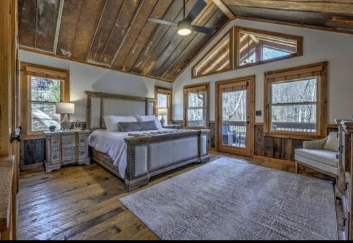a bedroom with a bed and a couch and windows at Mountain views, Fire Pit, Game Room in Hurst