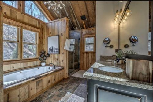 a bathroom with a tub and two sinks at Mountain views, Fire Pit, Game Room in Hurst