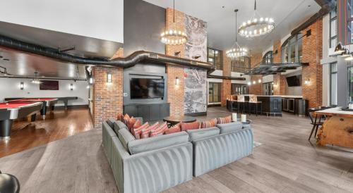 a living room with couches and ping pong tables at The Stay 2 - Navy Yard Washington DC in Washington