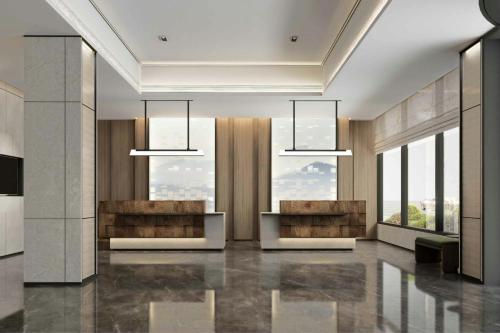 a lobby with two chandeliers in a building at Fairfield by Marriott Shanghai Xuhui Center in Shanghai