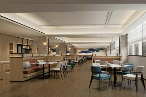 a restaurant with tables and chairs and a bar at Fairfield by Marriott Shanghai Xuhui Center in Shanghai