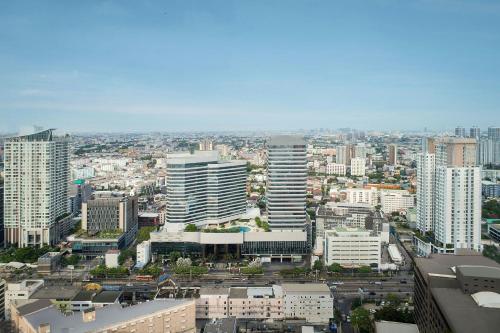 a view of a city with many tall buildings at Jubilee Prestige Hotel Ratchadapisek in Bangkok