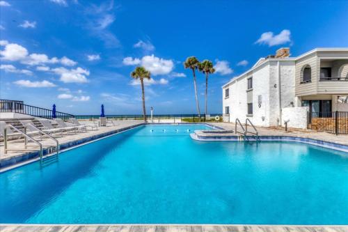 a pool with blue water in front of a building at 1555 Tarpon Center #B212 in Venice Beach