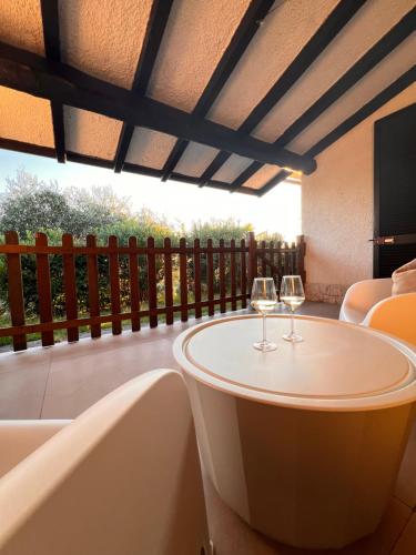 two glasses of wine sitting on a table on a patio at Casa Jeyel in Lazise