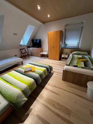 a bedroom with two beds with green blankets at Zentrales Apartment in Würzburg-Heidingsfeld in Würzburg